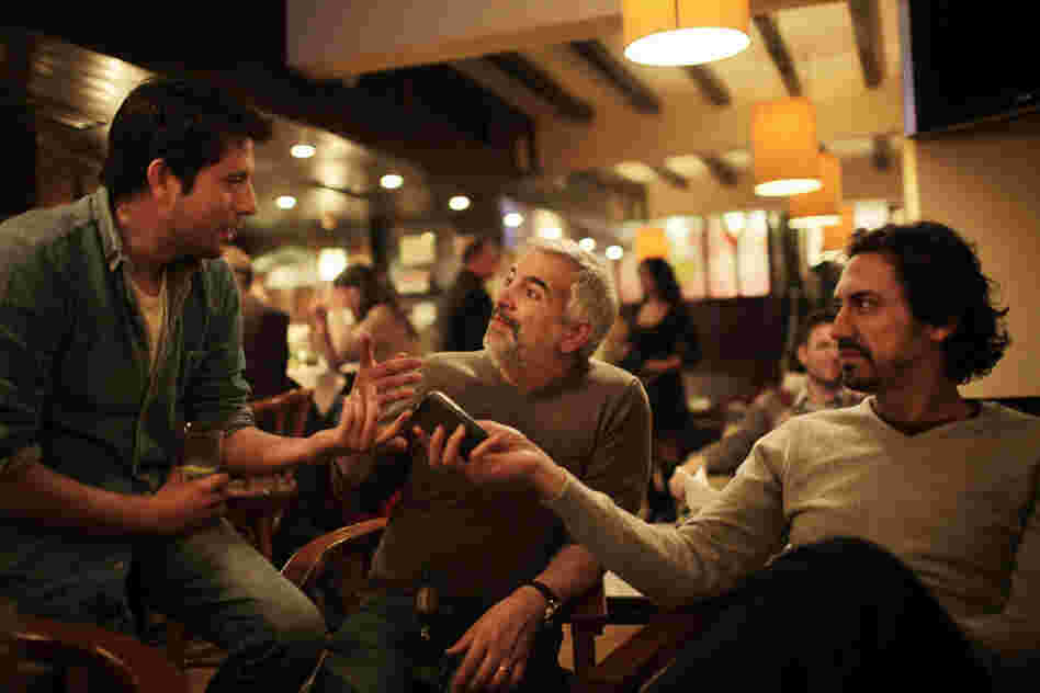 Shadid (center) shares a story with colleagues Moises Saman (left) and Kareem Fahim (right) in a  Cairo restaurant after the fall of Egyptian President Hosni Mubarak last year. 