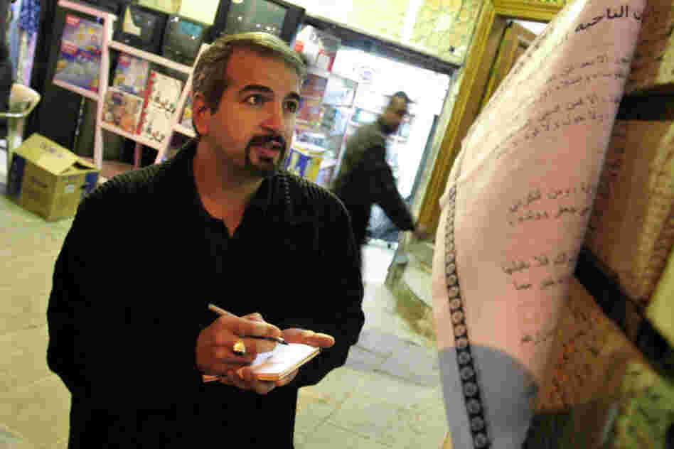Shadid takes notes outside the Najaf office of Grand Ayatollah Sistani, a leading Shiite figure in Iraq, in 2003. 