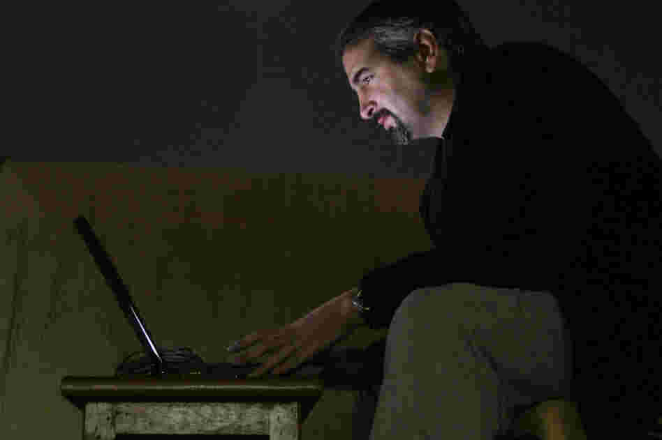 Pulitzer Prize-winning journalist Anthony Shadid died of an apparent asthma attack on Feb. 16, while on a reporting trip in Syria. Pictured here in 2003, while working for The Washington Post, Shadid types by moonlight on a hotel rooftop in Najaf, south of Baghdad, Iraq. 