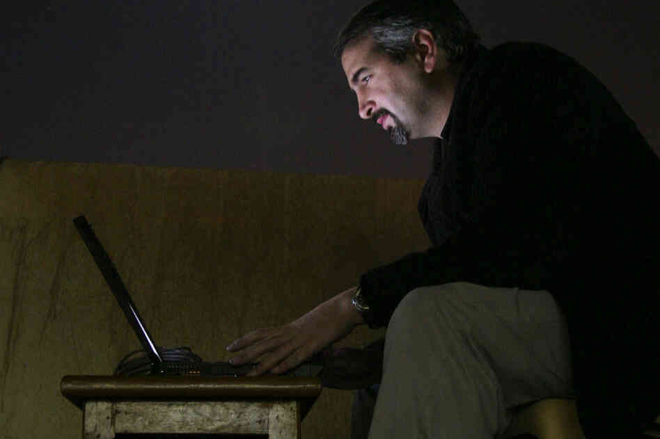 Pulitzer Prize-winning journalist Anthony Shadid died of an apparent asthma attack on Feb. 16, while on a reporting trip in Syria. Pictured here in 2003, while working for The Washington Post, Shadid types by moonlight on a hotel rooftop in Najaf, south of Baghdad, Iraq. 