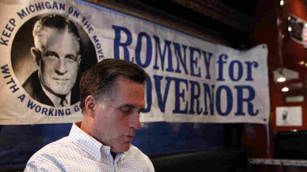 Mitt Romney works Thursday in Michigan aboard his campaign bus, which displays a poster for his late father, former Michigan Gov. George Romney. Despite deep roots in the state, Romney finds himself battling a candidate who has barely visited. Mitt Romney works Thursday in Michigan aboard his campaign bus, which displays a poster for his late father, former Michigan Gov. George Romney. Despite deep roots in the state, Romney finds himself battling a candidate who has barely visited.