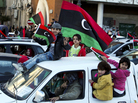 Children in Tripoli, Libya, wave a national flag from a car as people celebrate the one-year anniversary of the beginning of Libya's revolution, Feb. 16 2012. Children in Tripoli, Libya, wave a national flag from a car as people celebrate the one-year anniversary of the beginning of Libya's revolution, Feb. 16 2012.