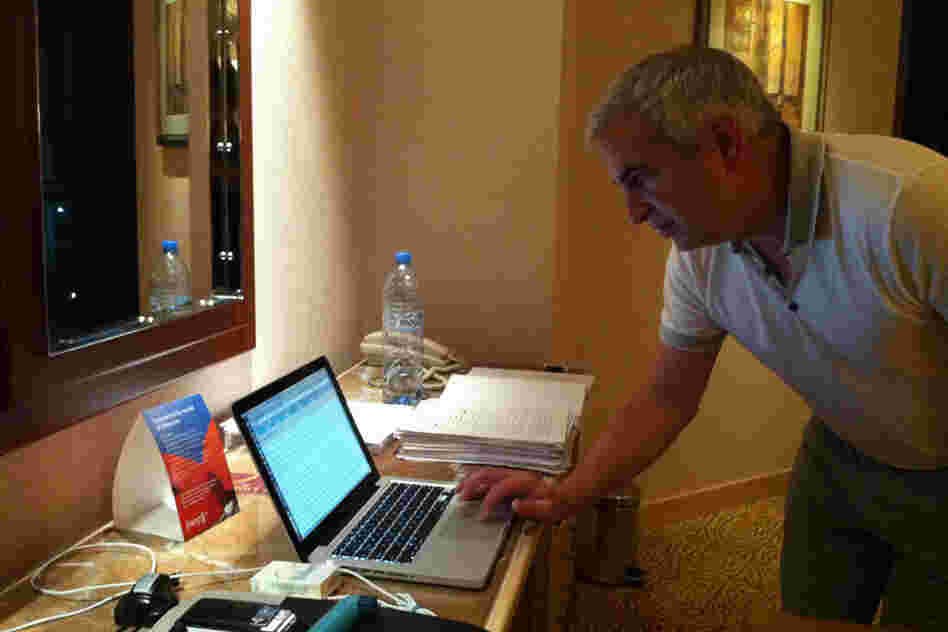 A new book by Shadid, House of Stone, will be published next month. Here, he balances reporting in Manama, Bahrain, with tweaking the manuscript (to his right). 