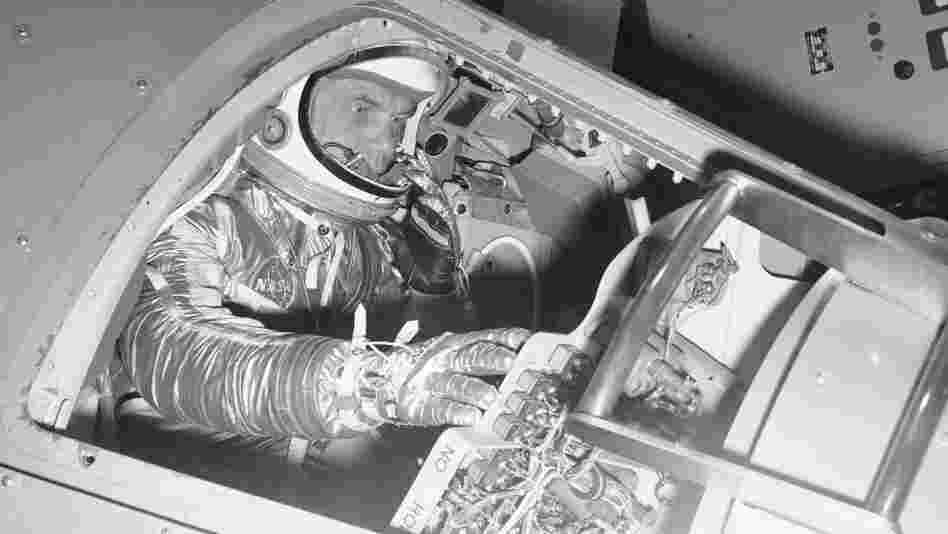 Marine Lt. Col. John Glenn demonstrates operations inside a Mercury capsule on Jan. 11, 1961. 
