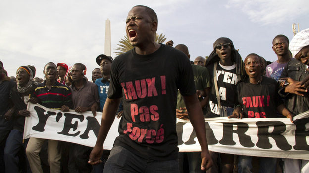 "Don't force it, give up!" reads the t-shirt of a protester during a rally opposing President Abdoulaye Wade's bid for a third term. The slogan comes from Y'en A Marre's signature song, "Abdoulaye, Faux! Pas Force."s opposed to President Abdoulaye Wade running for a third term 
