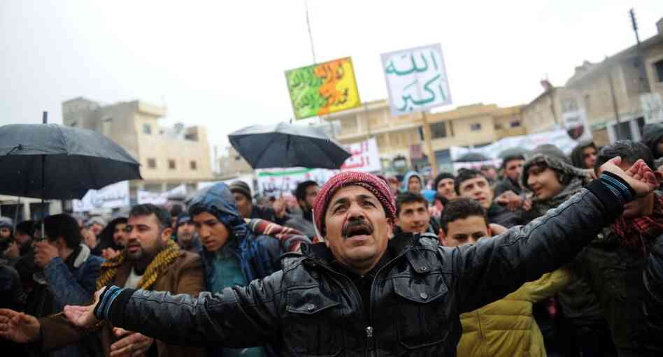 Syrians demonstrate against the regime after Friday prayers in the north Syrian city of Idlib on Friday. Thousands of Syrians rallied to demand Bashar al-Assad's ouster, as the embattled president's forces unleashed their heaviest pounding yet of Homs in a brutal bid to crush dissent, monitors said. 
