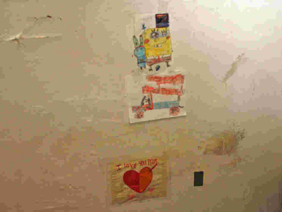  David Jimenez, 7, patches up holes in his East Oakland, Calif., apartment. The bottom sticky note says, "I love you Papi." 