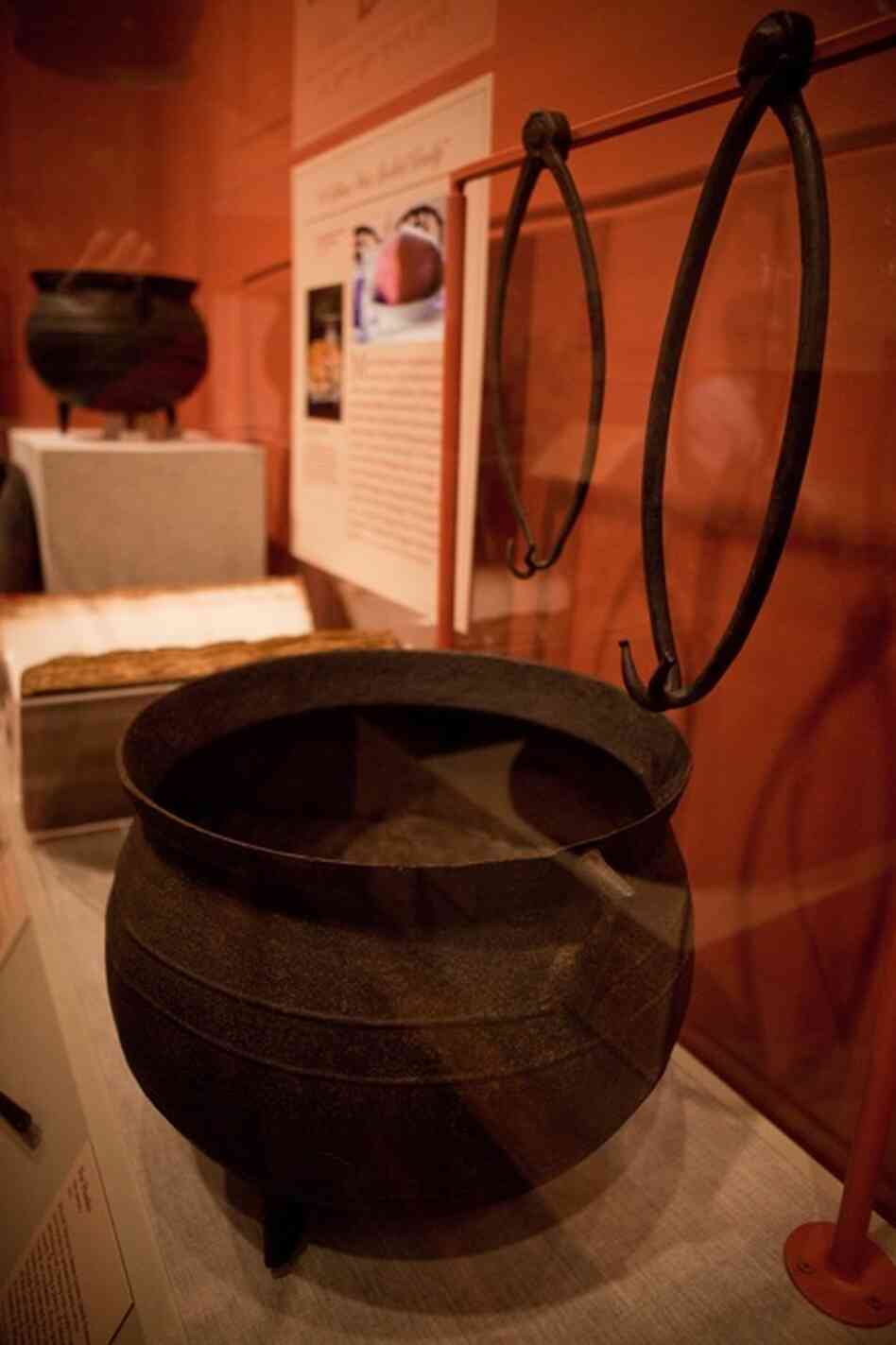 These large iron pots from the Mount Vernon kitchen were probably used to cook large cuts of meat like ham, beef and fowl. The metal hooks were used to pull the giant pots out of the fire.