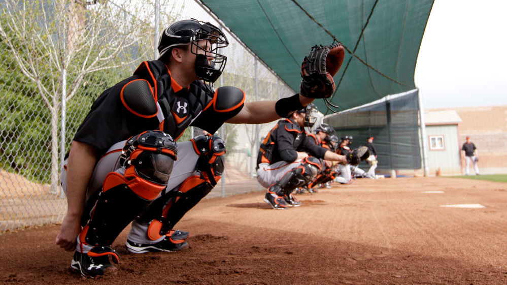 Catcher Buster Posey, seen here during a spring training workout Sunday, has been told by the San Francisco Giants that he should avoid blocking home plate. Posey broke his leg on a scoring play at the plate last season.