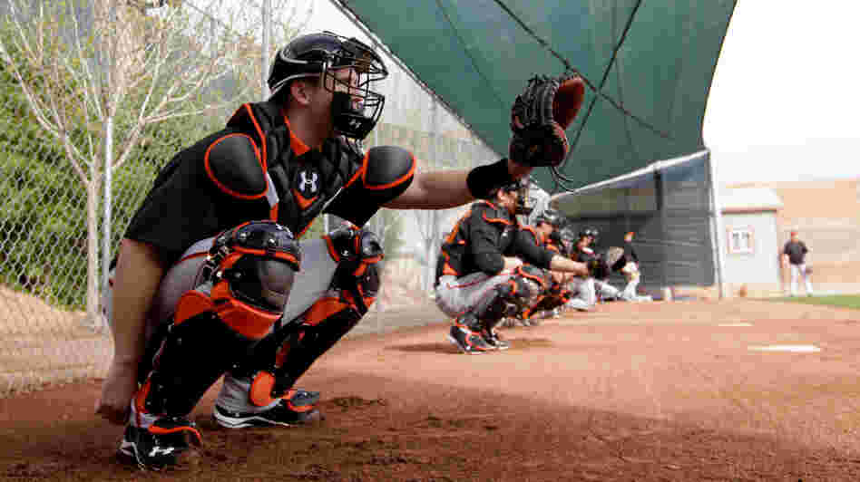 Catcher Buster Posey, seen here during a spring training workout Sunday, has been told by the San Francisco Giants that he should avoid blocking home plate. Posey broke his leg on a scoring play at the plate last season.