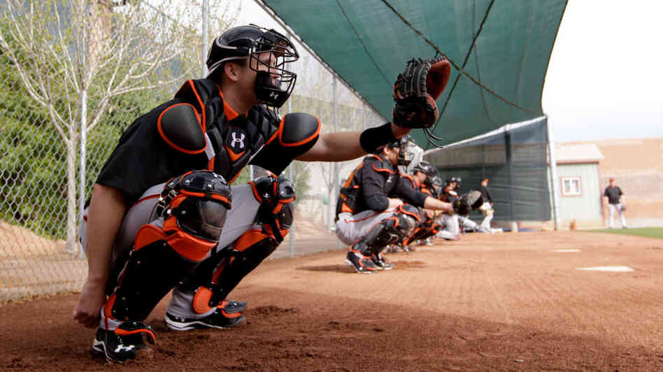Catcher Buster Posey, seen here during a spring training workout Sunday, has been told by the San Francisco Giants that he should avoid blocking home plate. Posey broke his leg on a scoring play at the plate last season.