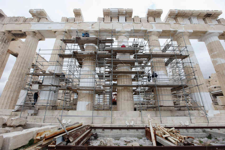 Restoration work on the pillars of the Parthenon atop Athens' Acropolis is symbolic of Europe's recent negotiations to save Greece from default.