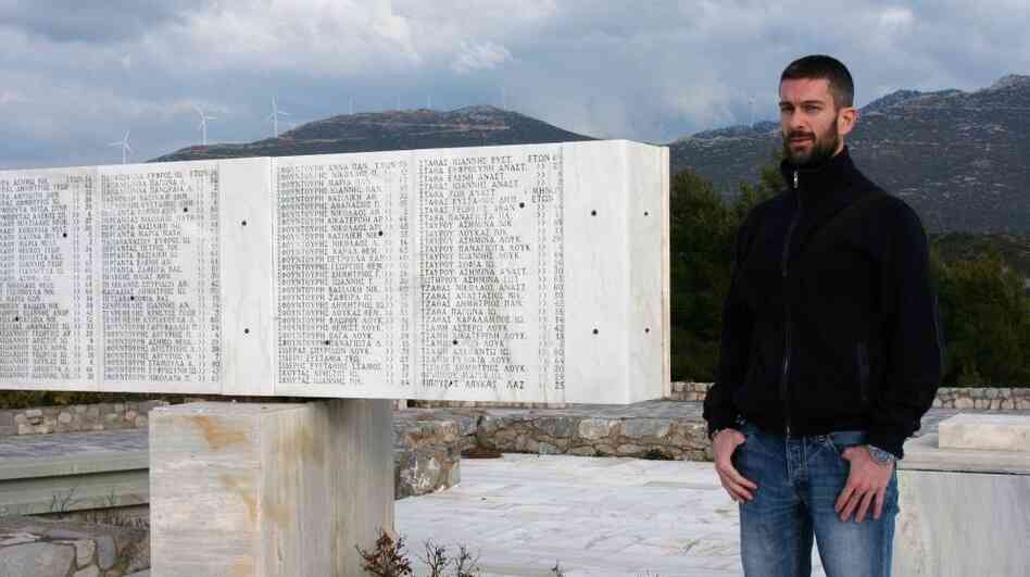 Nikos Bouras, 37, stands next to a monument for those massacred by the Nazis on June 10, 1944, that stands atop the highest hill in the Greek town of Distomo. Nikos Bouras, 37, stands next to a monument for those massacred by the Nazis on June 10, 1944, that stands atop the highest hill in the Greek town of Distomo.