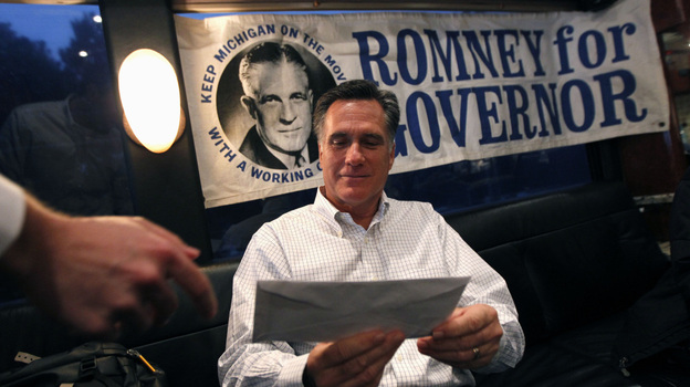 Republican presidential candidate, former Massachusetts Gov. Mitt Romney is handed mail by an aide on his campaign bus between campaign stops in Monroe, Mich., and Farmington Hills, Mich.