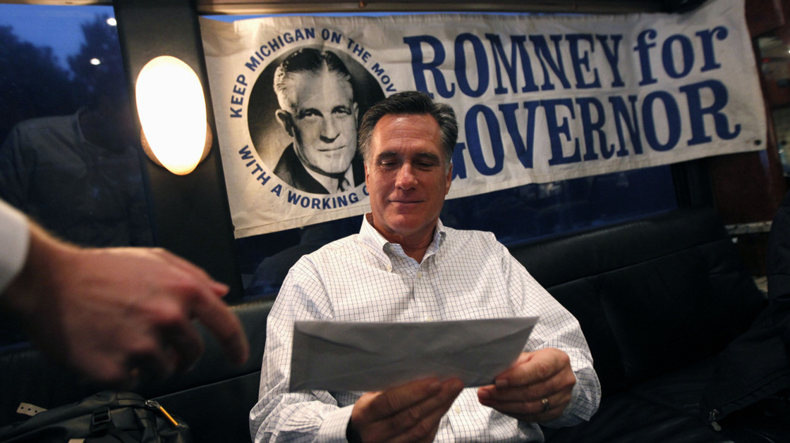 Republican presidential candidate, former Massachusetts Gov. Mitt Romney is handed mail by an aide on his campaign bus between campaign stops in Monroe, Mich., and Farmington Hills, Mich.