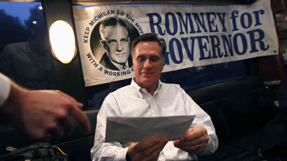 Republican presidential candidate, former Massachusetts Gov. Mitt Romney is handed mail by an aide on his campaign bus between campaign stops in Monroe, Mich., and Farmington Hills, Mich.