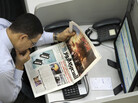 An Egyptian stock trader reads a copy of the Al-Masry Al-Youm newspaper last November. Critics say the newspaper is reluctant to criticize the ruling military council and has engaged in self-censorship. An Egyptian stock trader reads a copy of the Al-Masry Al-Youm newspaper last November. Critics say the newspaper is reluctant to criticize the ruling military council and has engaged in self-censorship.