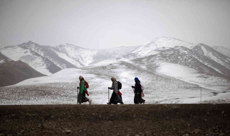 Ethnic Tibetan pilgrims walk on a road during Tibetan New Year in Langmusixiang, Sichuan province, in western China, Feb. 22. Celebrations are subdued in the Tibetan areas of China this year, after a string of self-immolations and protest against Chinese control.