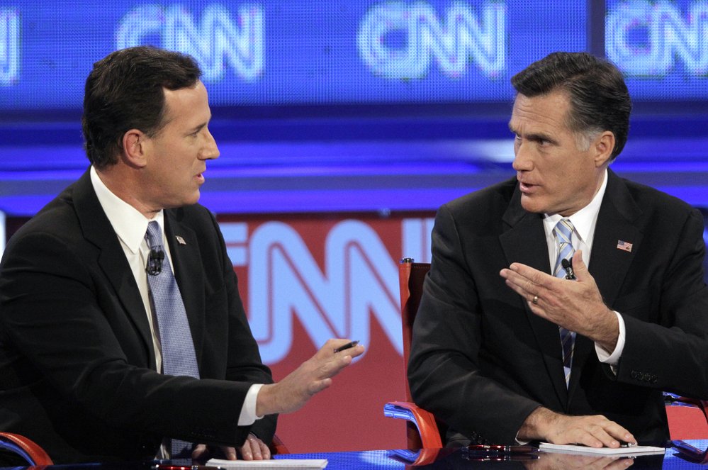 Mitt Romney debates a point with Rick Santorum during a Republican presidential debate on Wednesday.