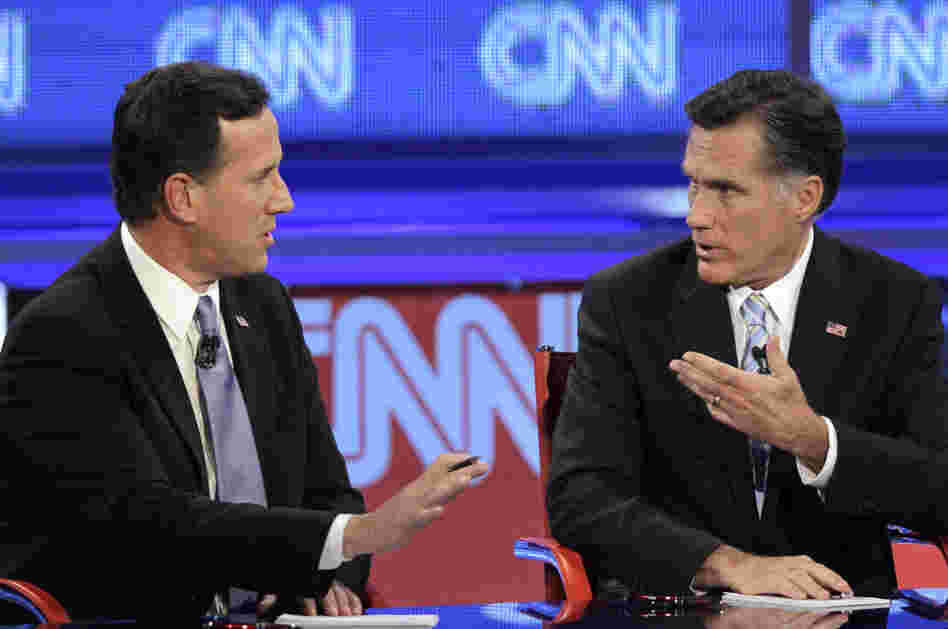 Mitt Romney debates a point with Rick Santorum during a Republican presidential debate on Wednesday.