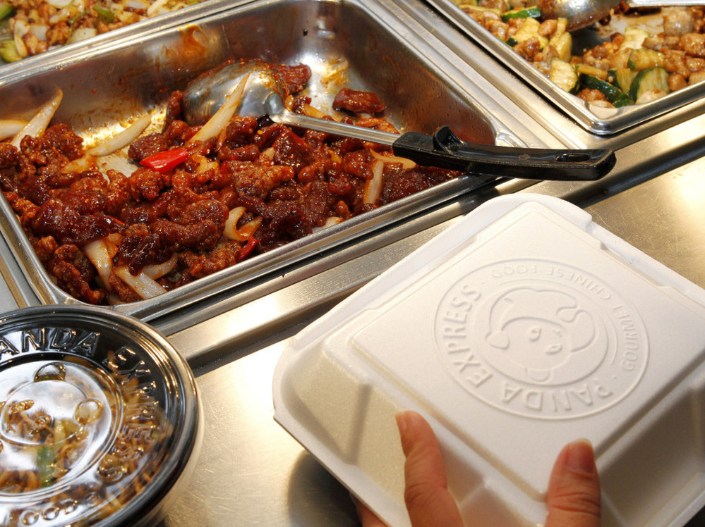 An employee packs a customer's takeout order at a Panda Express restaurant in Los Angeles.