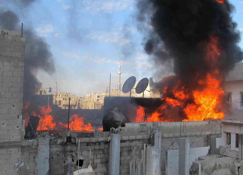 A handout picture released by Local coordination Committees in Syria (LCC Syria) on Feb. 22 shows fire on the roof of a building in the Baba Amr neighborhood of the flashpoint city of Homs.