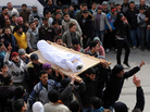 Syrians today carried the body of a youth reportedly killed in violence in the Idlib region. Syrians today carried the body of a youth reportedly killed in violence in the Idlib region.