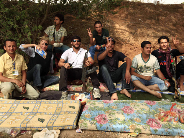 Journalist Marie Colvin (second from left) poses with Libyan rebels in Misrata on June 4, 2011. She was killed in the besieged Syrian city of Homs on Wednesday. Later that day in Tripoli, fellow war correspondents gathered to remember her.