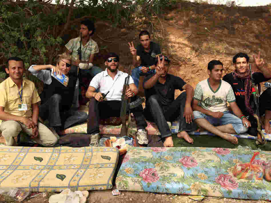 Journalist Marie Colvin (second from left) poses with Libyan rebels in Misrata on June 4, 2011. She was killed in the besieged Syrian city of Homs on Wednesday. Later that day in Tripoli, fellow war correspondents gathered to remember her.
