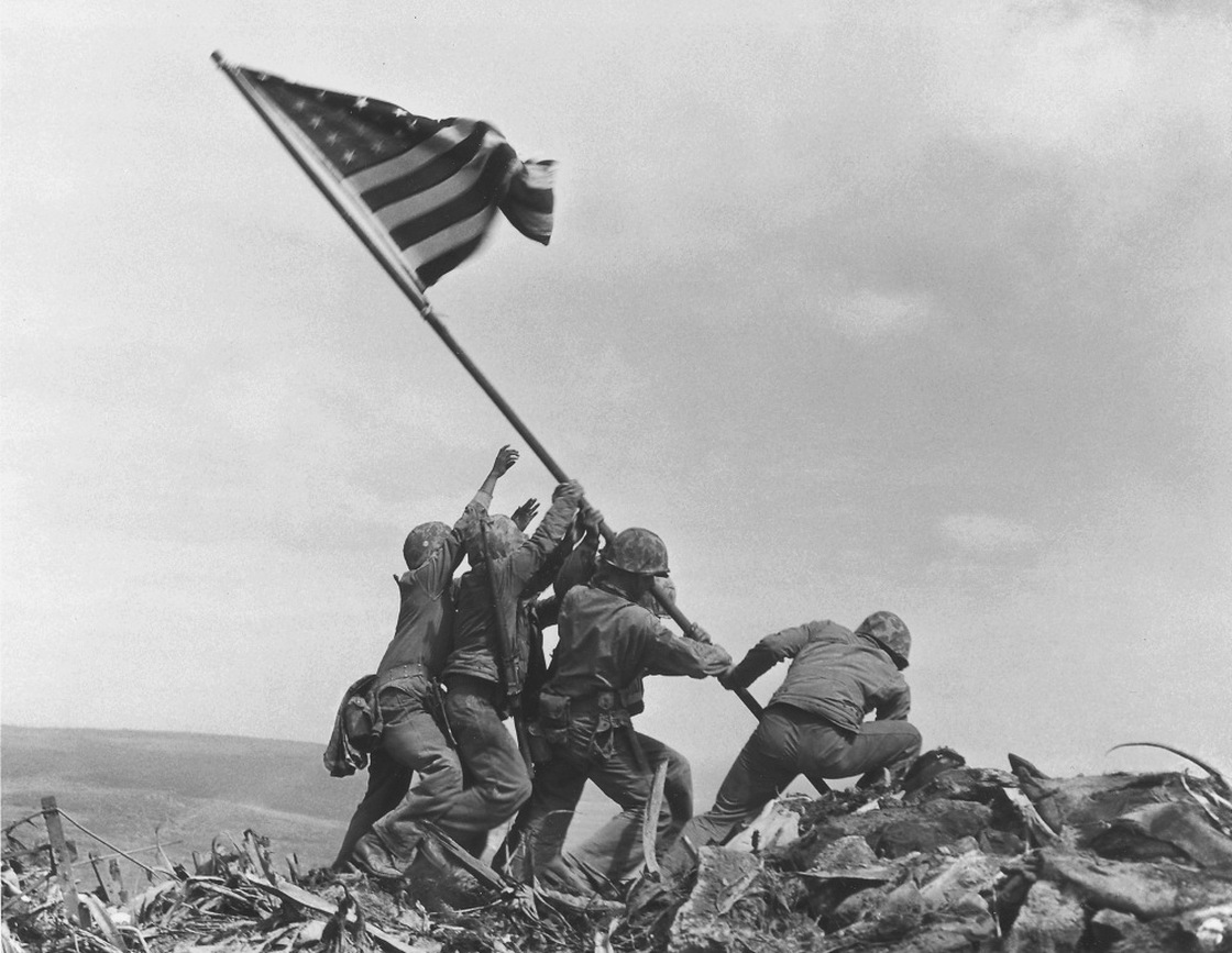 U.S. Marines of the 28th Regiment, 5th Division, raise the American flag atop Mount Suribachi at Iwo Jima, on Feb. 23, 1945.