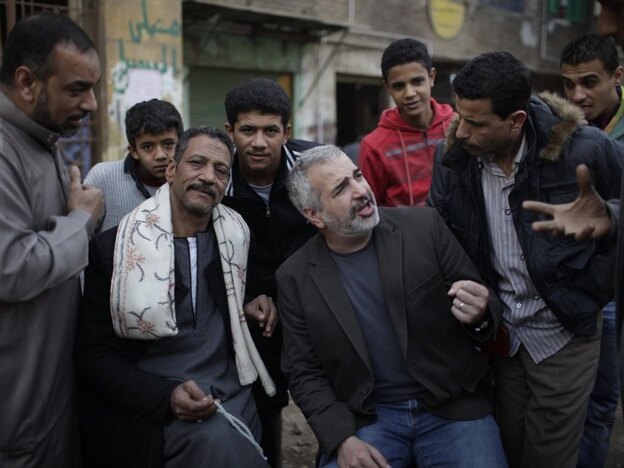 New York Times journalist Anthony Shadid often wrote about ordinary citizens caught up in war zones. Shadid (center), who died last week in Syria, is shown here talking to Egyptians in Cairo during the revolution that toppled then-President Hosni Mubarak in February 2011.