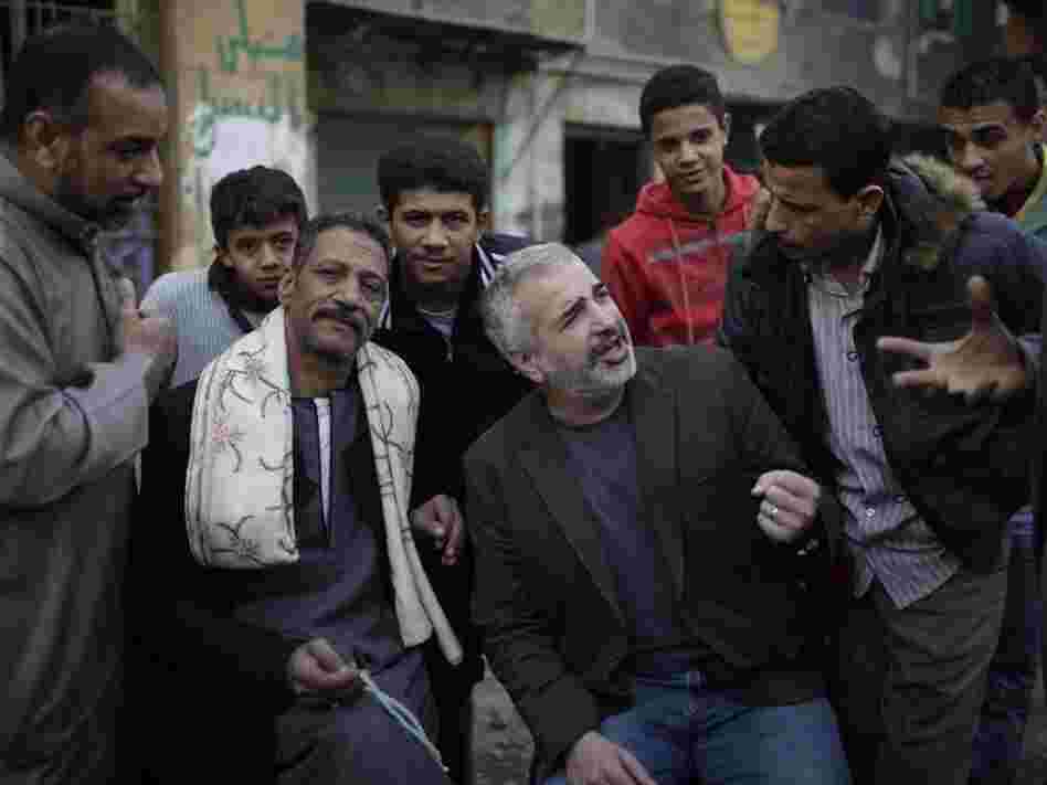 New York Times journalist Anthony Shadid often wrote about ordinary citizens caught up in war zones. Shadid (center), who died last week in Syria, is shown here talking to Egyptians in Cairo during the revolution that toppled then-President Hosni Mubarak in February 2011.