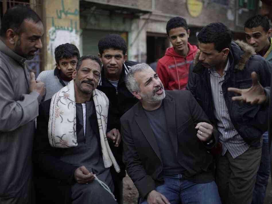 New York Times journalist Anthony Shadid often wrote about ordinary citizens caught up in war zones. Shadid (center), who died last week in Syria, is shown here talking to Egyptians in Cairo during the revolution that toppled then-President Hosni Mubarak in February 2011.