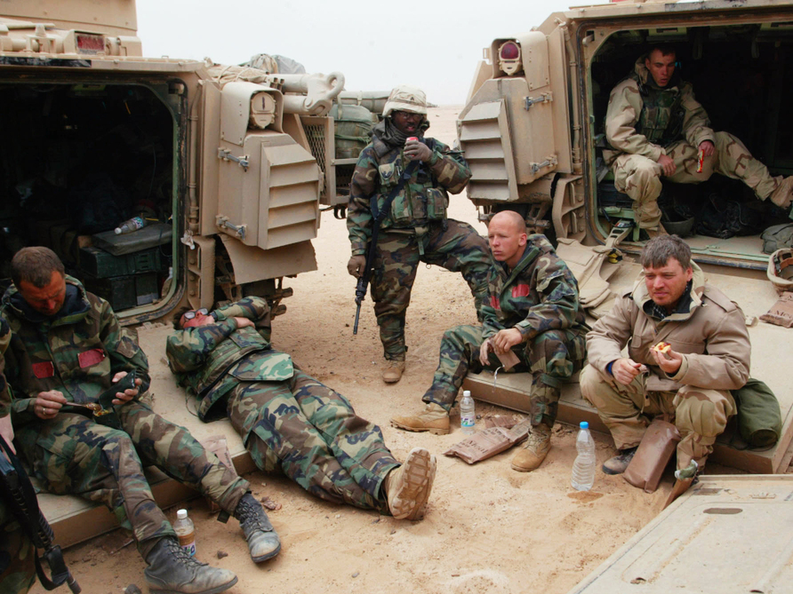 War correspondents traditionally covered conflicts by traveling with armies. Here, Associated Press reporter Chris Tomlinson, (right) is shown with U.S. forces in Iraq in 2003. But in many modern wars, reporters operate independently on the rebel side of the fighting, which raises the risks.