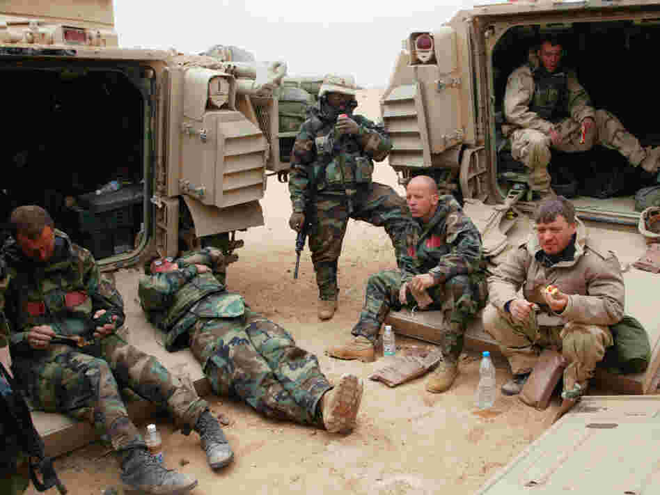 War correspondents traditionally covered conflicts by traveling with armies. Here, Associated Press reporter Chris Tomlinson, (right) is shown with U.S. forces in Iraq in 2003. But in many modern wars, reporters operate independently on the rebel side of the fighting, which raises the risks.