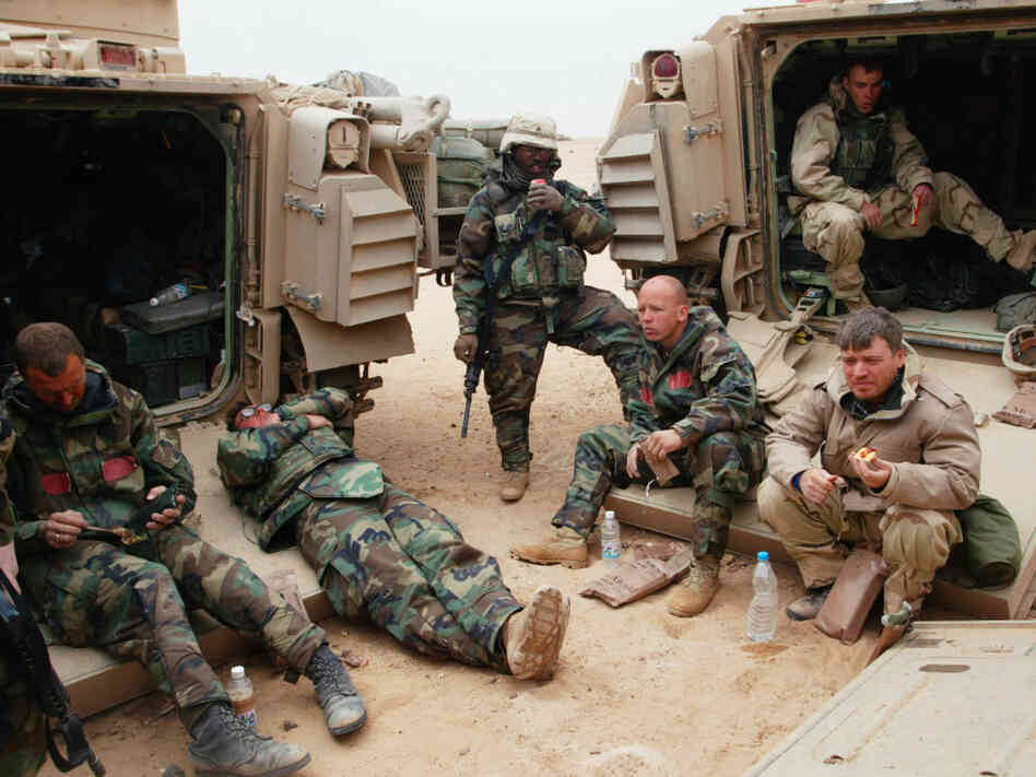 War correspondents traditionally covered conflicts by traveling with armies. Here, Associated Press reporter Chris Tomlinson, (right) is shown with U.S. forces in Iraq in 2003. But in many modern wars, reporters operate independently on the rebel side of the fighting, which raises the risks.