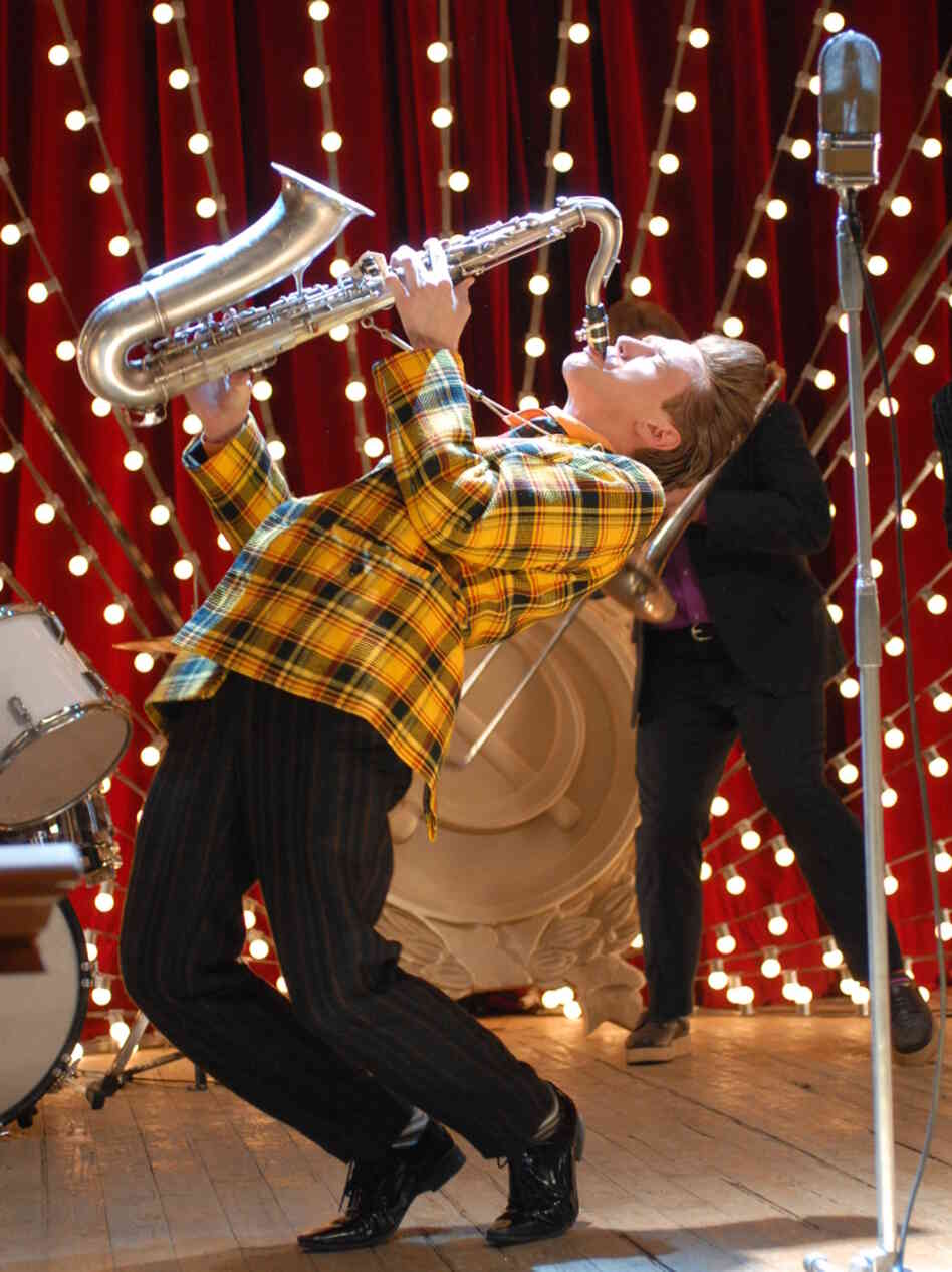 Mels (Anton Shagin) drops his modest gray attire, throws on a zoot suit, and picks up a saxophone when he meets pretty girl Polly (Oksana Akinshina). Mels (Anton Shagin) drops his modest gray attire, throws on a zoot suit, and picks up a saxophone when he meets pretty girl Polly (Oksana Akinshina).