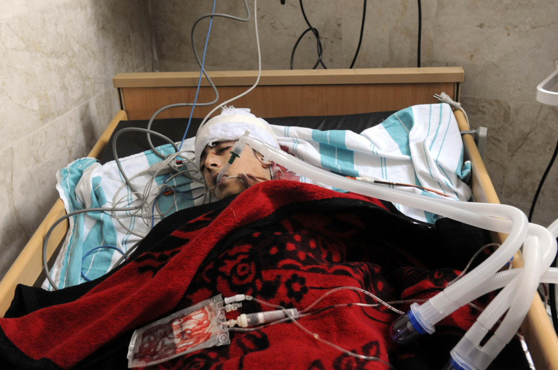 Zouheir Jabbour says many of the videos and images coming out of Syria are a fabrication. Here, a badly injured man lies in a bed at a makeshift clinic in the Syrian city of Idlib on Friday.