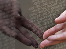 A visitor touches names engraved on a traveling half-scale replica of the Vietnam Veterans Memorial in Washington, D.C. A visitor touches names engraved on a traveling half-scale replica of the Vietnam Veterans Memorial in Washington, D.C.