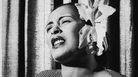 American blues singer Billie Holiday singing with an orchid in her hair. American blues singer Billie Holiday singing with an orchid in her hair.