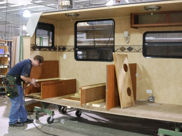 Clinton Lehman, who had been unemployed for nine months before being called back to work, assembles a recreation vehicle at the Jayco factory in Elkhart, Ind., in 2011.