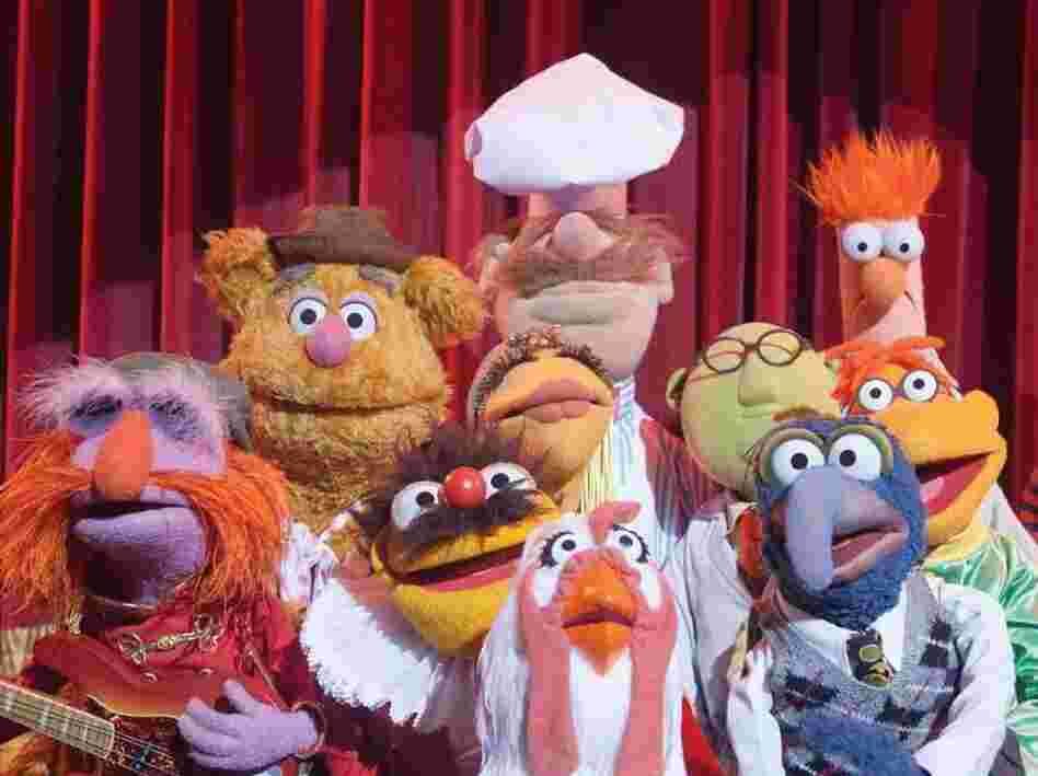 The cast of The Muppets includes (left to right) Floyd Pepper, Fozzie Bear, Lew Zealand, Janice, Swedish Chef, Camilla The Chicken, Dr. Bunsen Honeydew, Gonzo, Scooter and Beaker.
