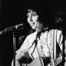 American country music singer and guitarist Loretta Lynn performs on stage at the Grand Ole Opry, 1960s. American country music singer and guitarist Loretta Lynn performs on stage at the Grand Ole Opry, 1960s.