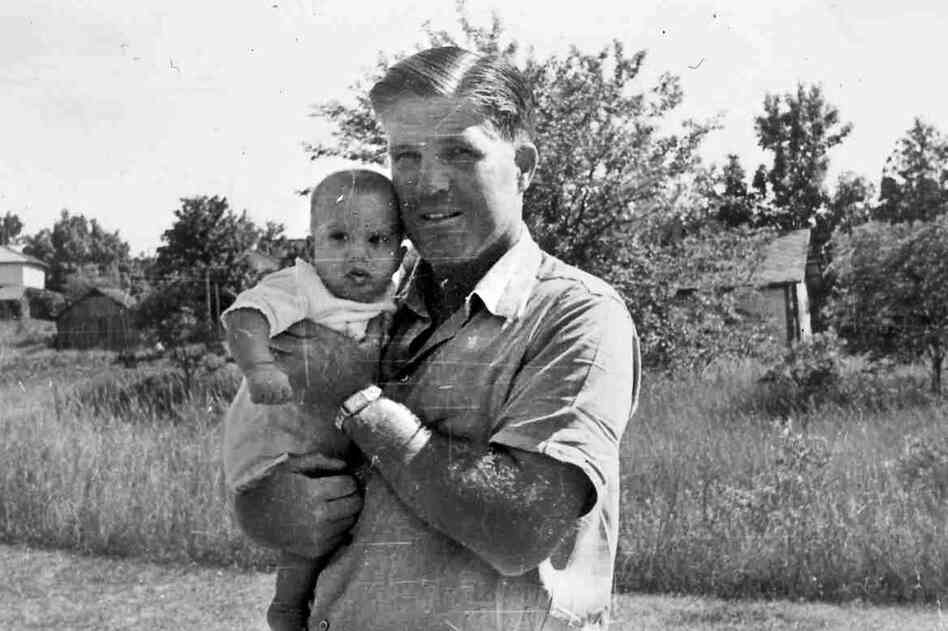 George Romney holds infant Willard "Mitt" Romney, the youngest of his four children, in this 1947 family photo.  