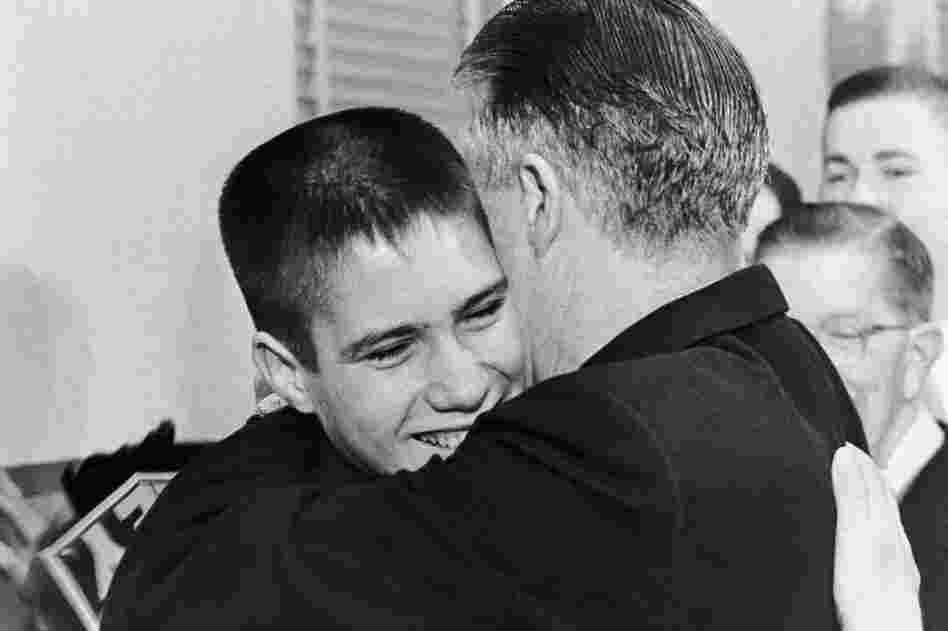A 14-year-old Mitt hugs his father after George Romney announces his candidacy for governor on Feb. 10, 1962.  