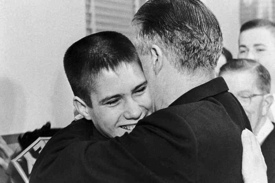A 14-year-old Mitt hugs his father after George Romney announces his candidacy for governor on Feb. 10, 1962.  