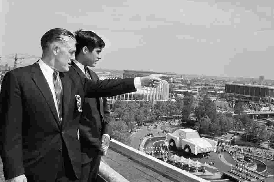 George and Mitt Romney look out over the grounds of the World's Fair in 1964. The World's Fair included exhibits from several automobile companies. 