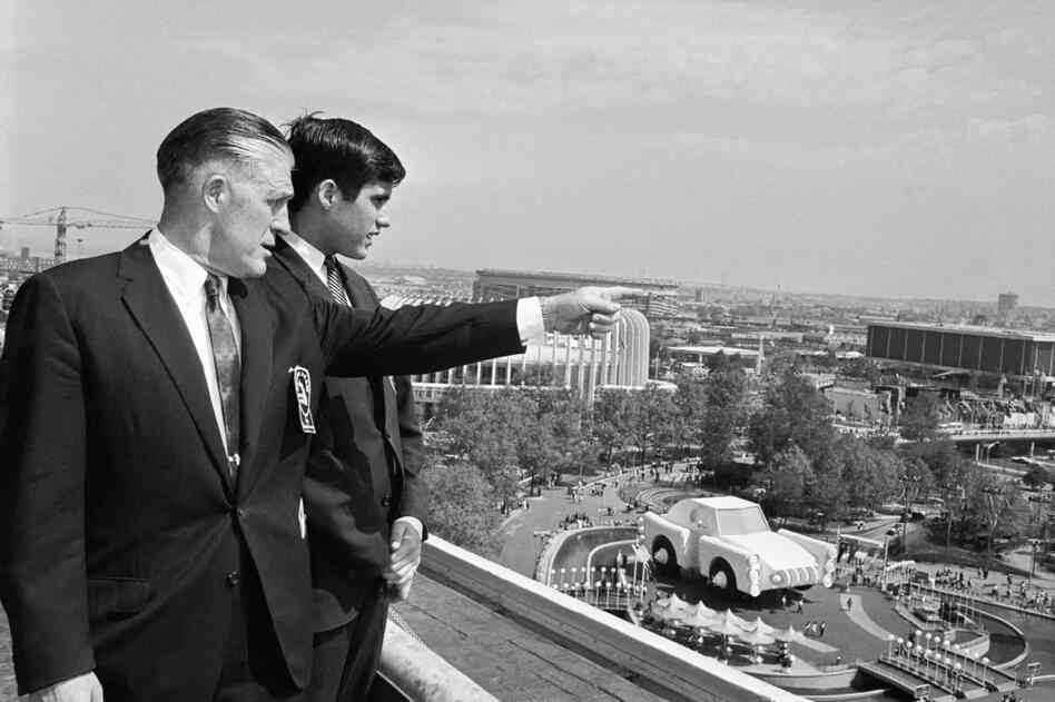 George and Mitt Romney look out over the grounds of the World's Fair in 1964. The World's Fair included exhibits from several automobile companies. 