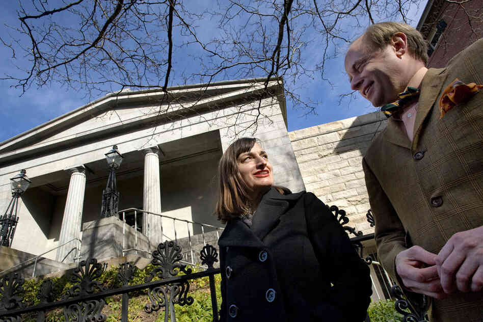 Christina Bevilacqua (left), director of programs and public engagement, and James Hall, executive director of the Providence Preservation Society, stand outside the Providence Athenaeum. 
