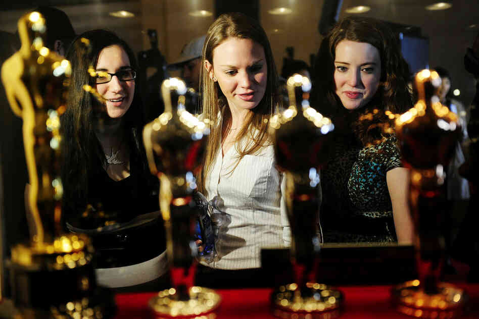 Oscar fans in New York take a closer look at the statuettes on display during the "Meet the Oscars, Grand Central" exhibition at Grand Central Station on Feb. 22. 